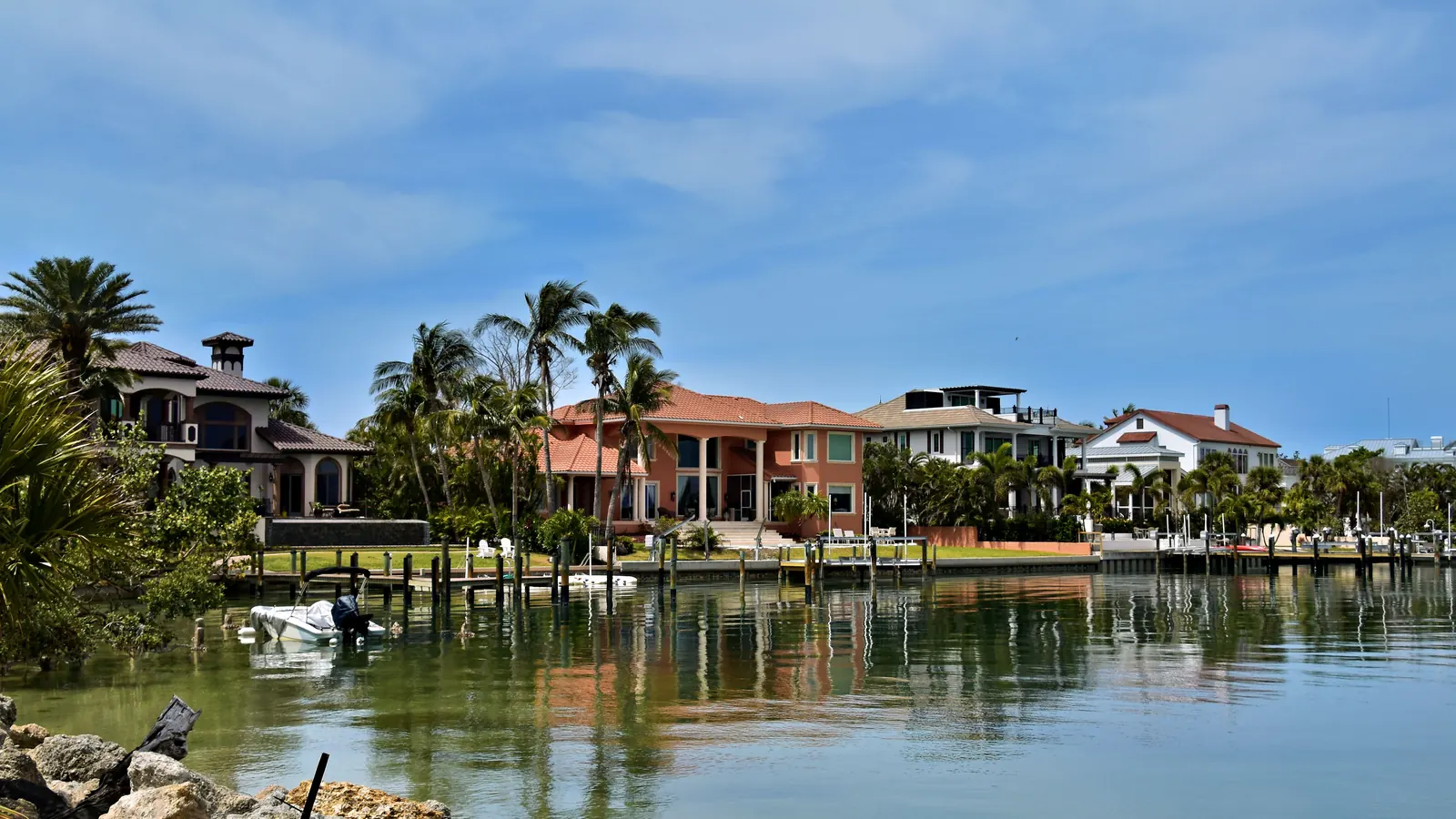 Waterfront houses with palms along a canal