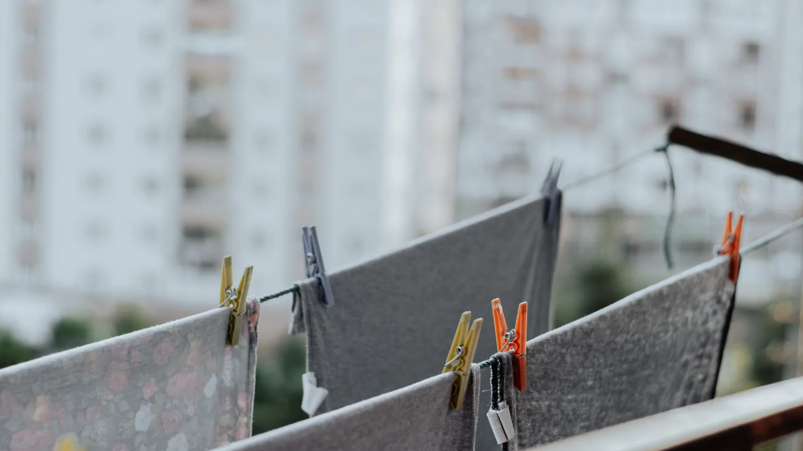 Clothes drying on a line with pins, towers blurred behind